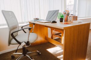 Professional home office workspace showing laptop and organized desk setup where AI tools are transforming everyday business productivity and AI Project ROI"